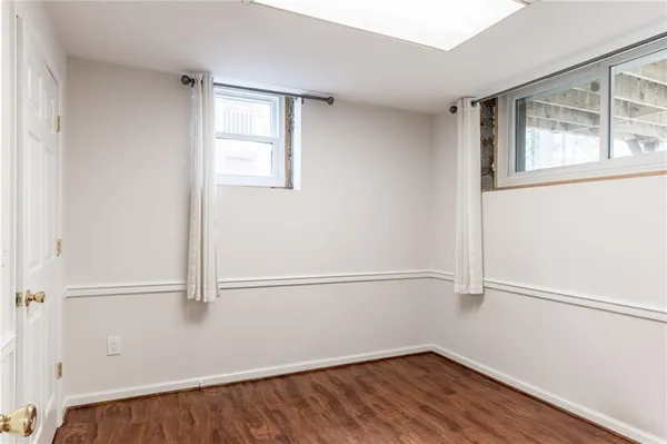 a view of a room with wooden floor and white walls