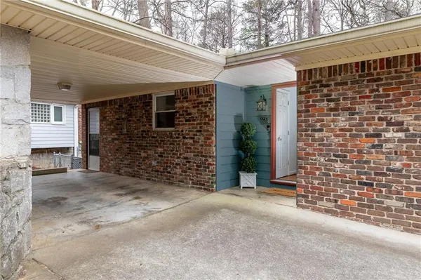 view of a brick house with large windows