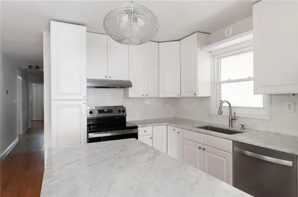 a kitchen with stainless steel appliances a stove and cabinets