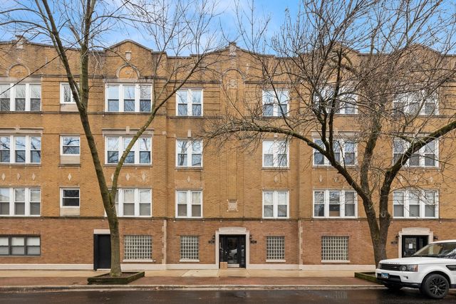 a front view of a residential apartment building with a yard
