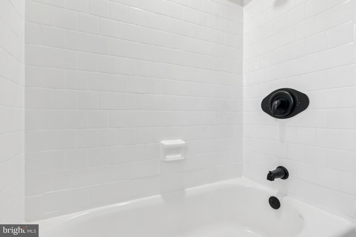 2037 38th Street Southeast, Unit 301 Washington, DC 20020 - Photo 13 of 15 a bathroom with a bathtub
