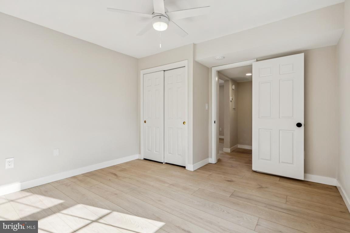 2037 38th Street Southeast, Unit 301 Washington, DC 20020 - Photo 15 of 15 an empty room with wooden floor and ceiling fan