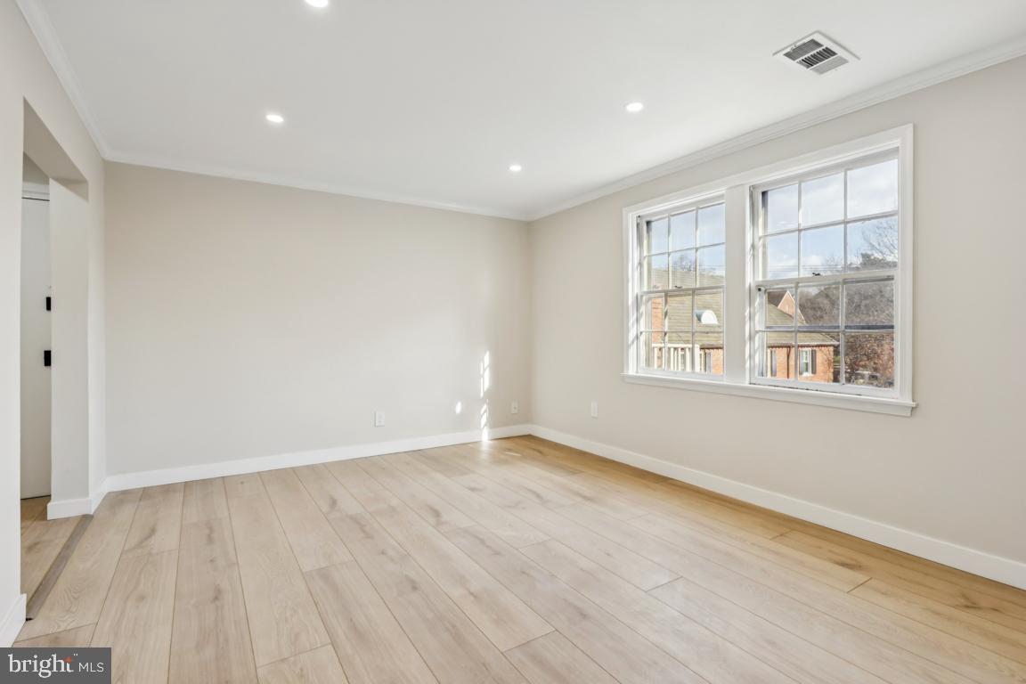 2037 38th Street Southeast, Unit 301 Washington, DC 20020 - Photo 10 of 15 wooden floor in an empty room with a window