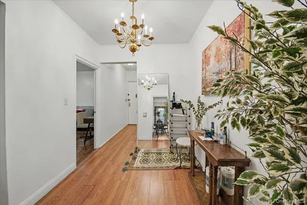 wooden floor with a chandelier