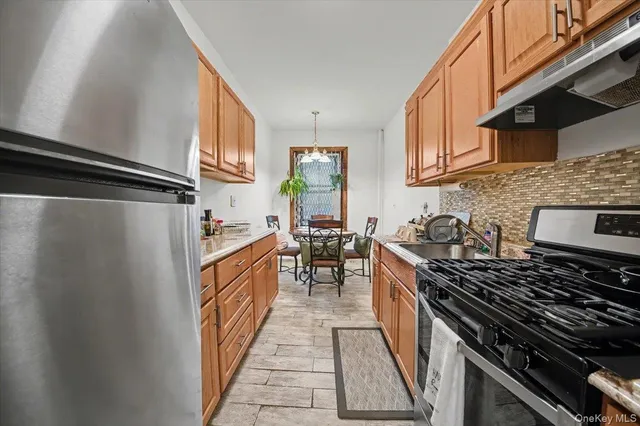 a kitchen with stainless steel appliances granite countertop a stove and a sink