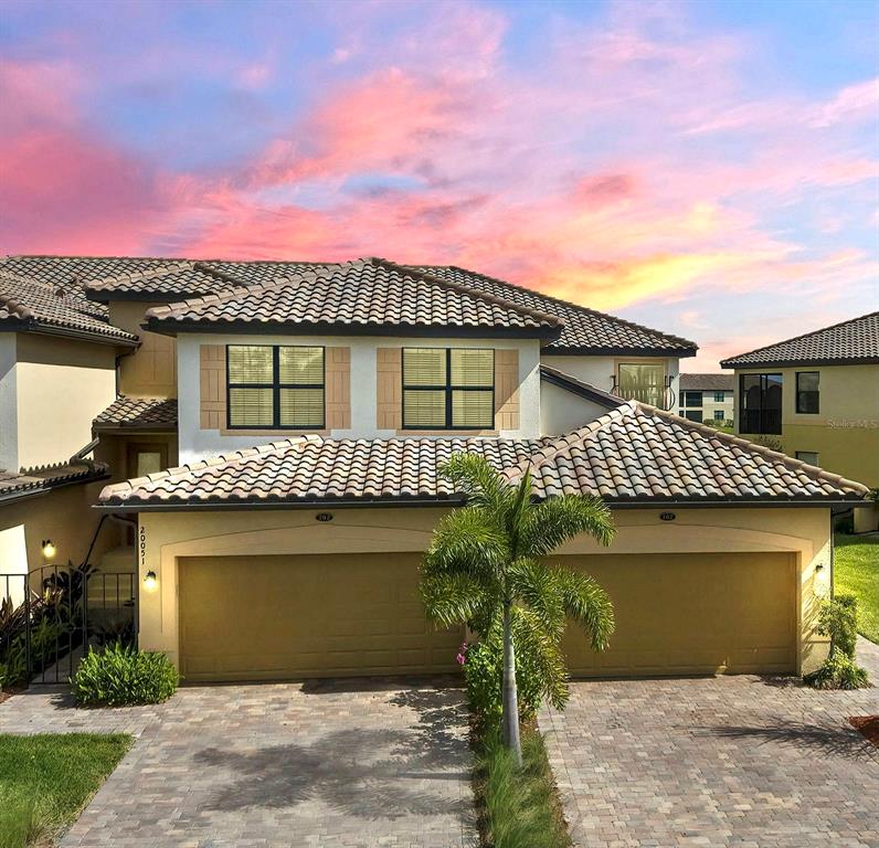 20051 Ragazza Circle, Unit 202 Venice, FL 34293 - Photo 1 of 1 Front of Condo at Twilight