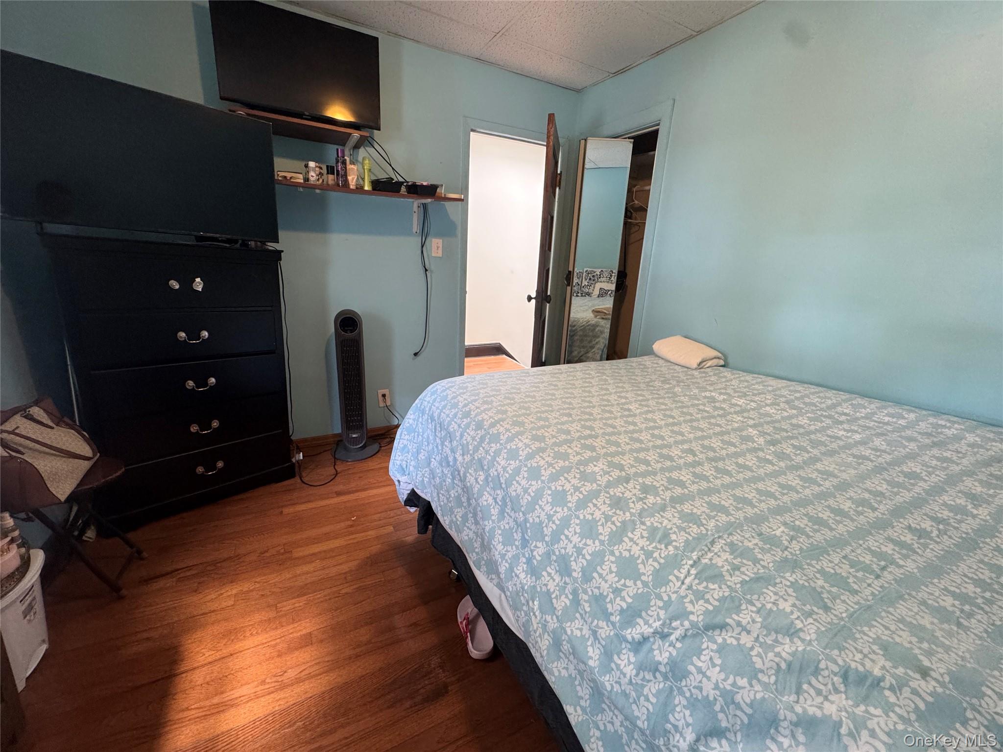 80-58 88th Road Queens, NY 11421 - Photo 13 of 21 a bedroom with a bed and a television