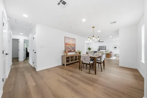 a view of a dining room with furniture and chandelier