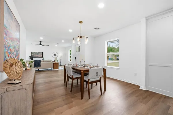 a view of a dining room with furniture and wooden floor