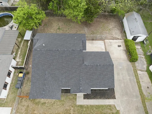 an aerial view of a house with a yard