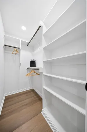 a room with walk in closet and a window
