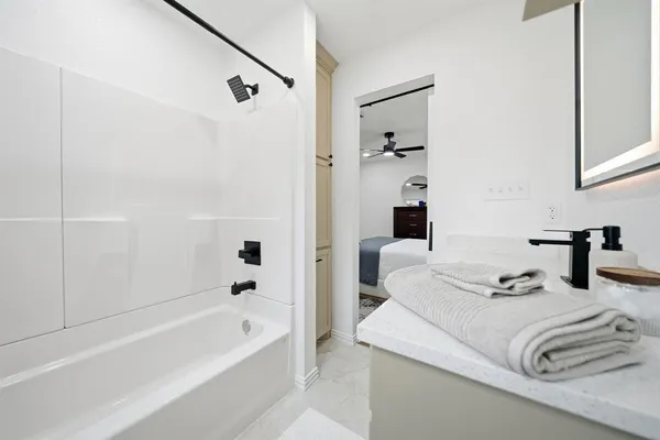 a bathroom with a bathtub and a shower