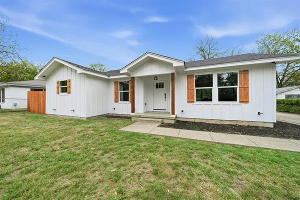 a house with a yard and front view of a house