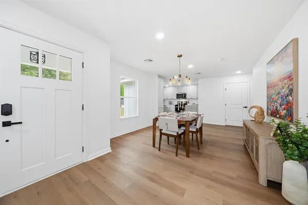 a view of a dining room with furniture and wooden floor