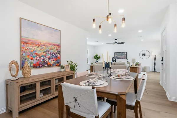 a view of a dining room with furniture wooden floor and a chandelier
