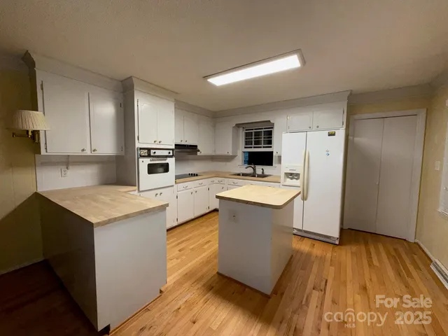a kitchen with a sink stove and refrigerator