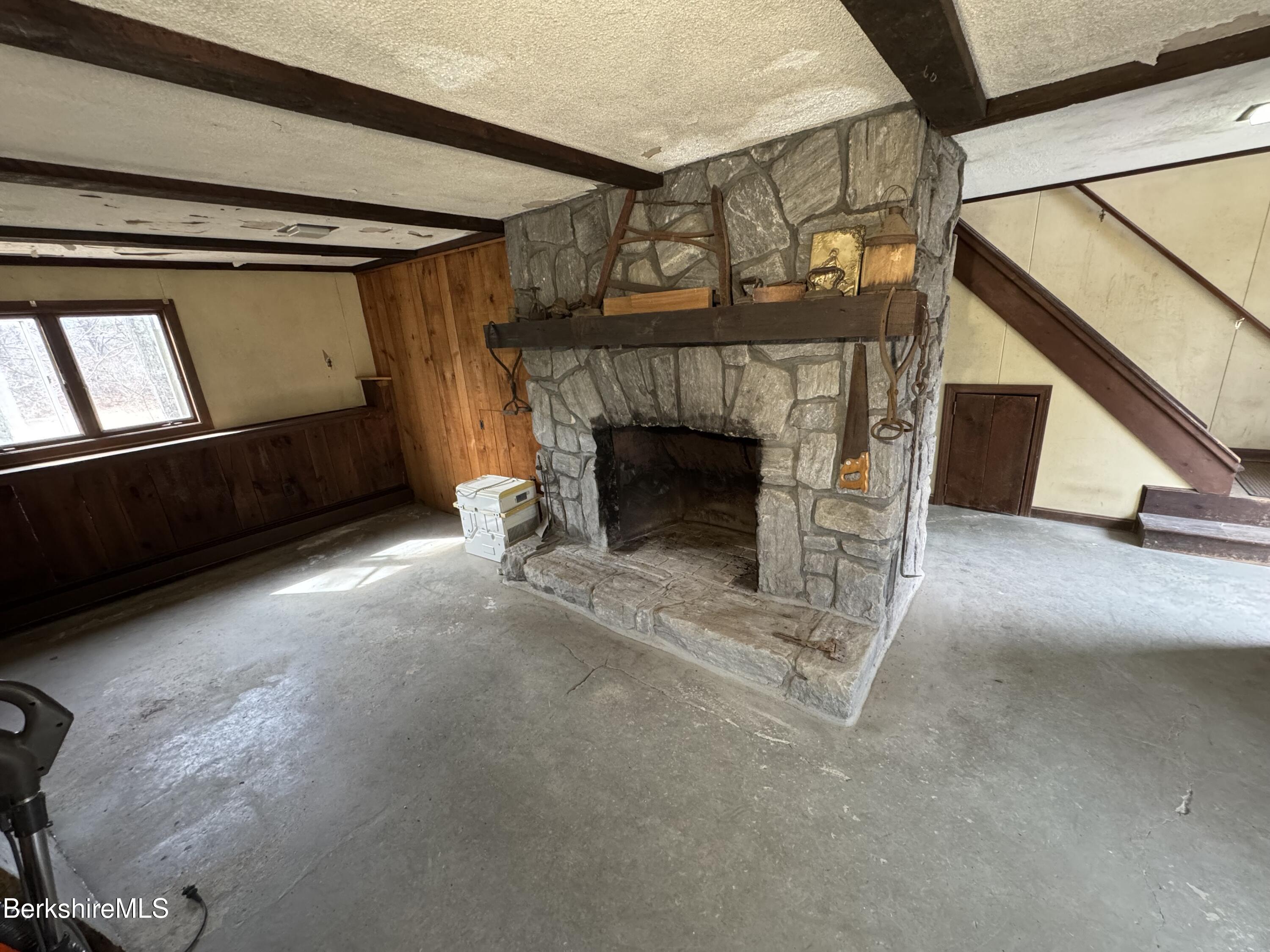 44 C Mt Washington Road Egremont, MA 01230 - Photo 18 of 25 a view of an empty room with wooden floor a fireplace and a window