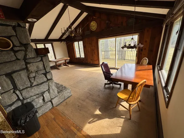 a view of kitchen with refrigerator and window