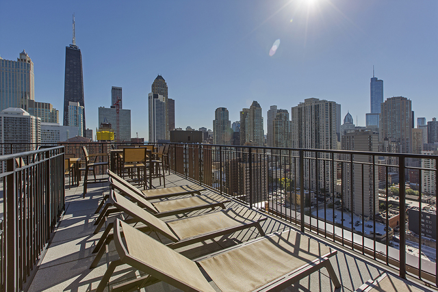 100 West Chestnut Street, Unit 1008 Chicago, IL 60610 - Photo 2 of 10 a view of a balcony with wooden benches