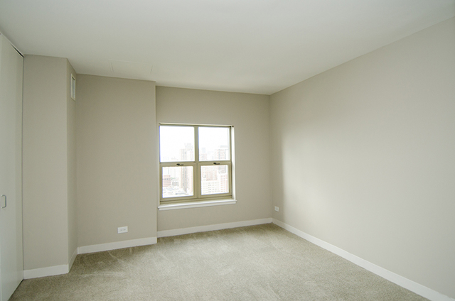100 West Chestnut Street, Unit 1008 Chicago, IL 60610 - Photo 7 of 10 an empty room with a window