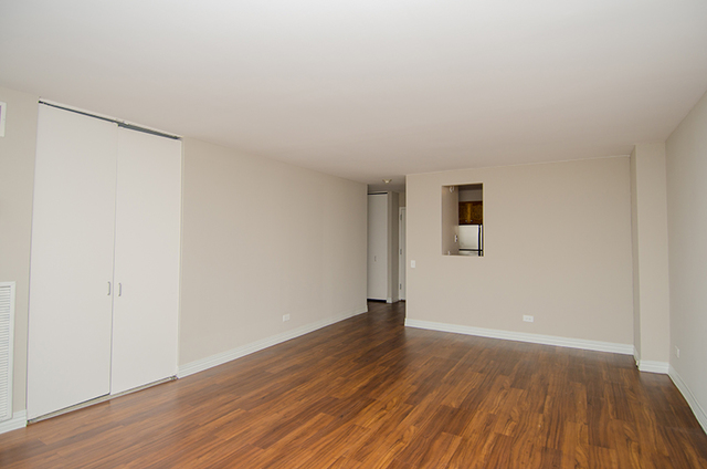 100 West Chestnut Street, Unit 1008 Chicago, IL 60610 - Photo 9 of 10 a view of an empty room with wooden floor