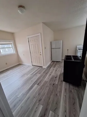 a view of a livingroom with wooden floor
