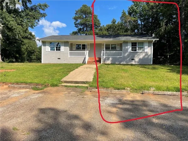 a view of a house with a yard potted plants