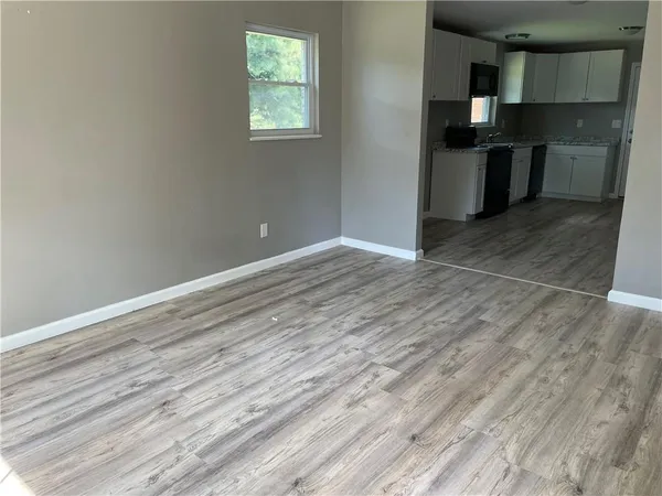 a kitchen with granite countertop a stove and cabinets