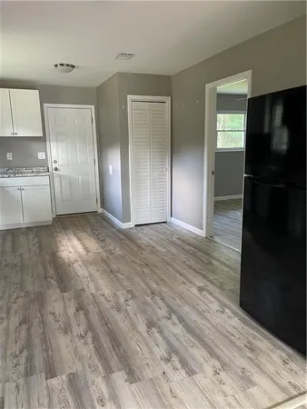 a view of a refrigerator in kitchen and wooden floor