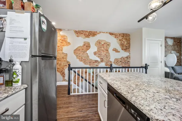 a view of a kitchen with a sink and refrigerator