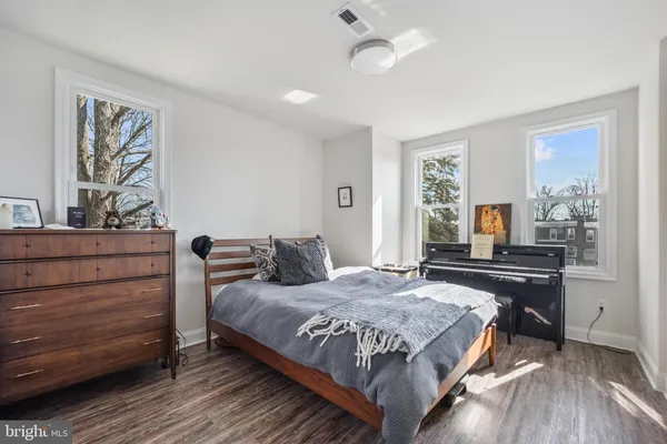 a bedroom with a bed and a dresser