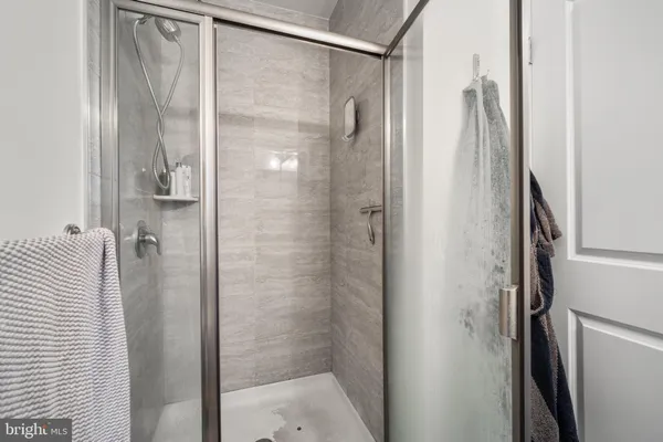 a bathroom with a shower and a glass door