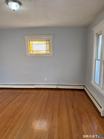 a view of a room with wooden floor and window