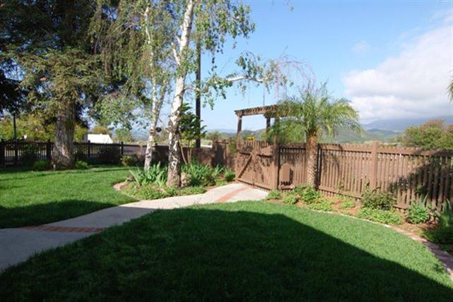 200 North Rice Road Ojai, CA 93023 - Photo 16 of 21 a view of a backyard with potted plants and large trees