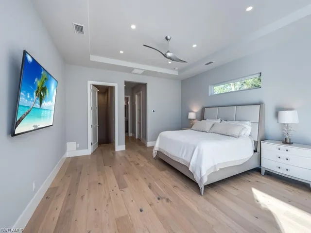 a bedroom with a bed and a painting on the wall