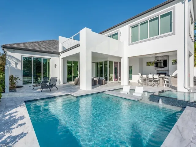 a front view of a house with garden and patio