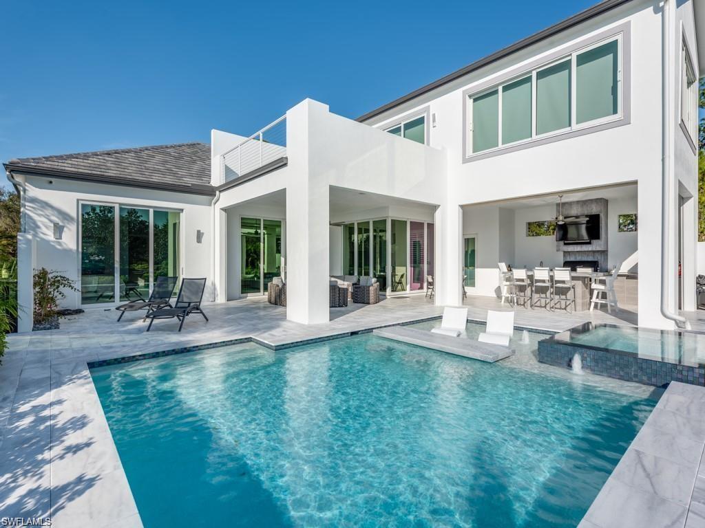 16892 Brightling Way Naples, FL 34110 - Photo 20 of 33 a front view of a house with garden and patio