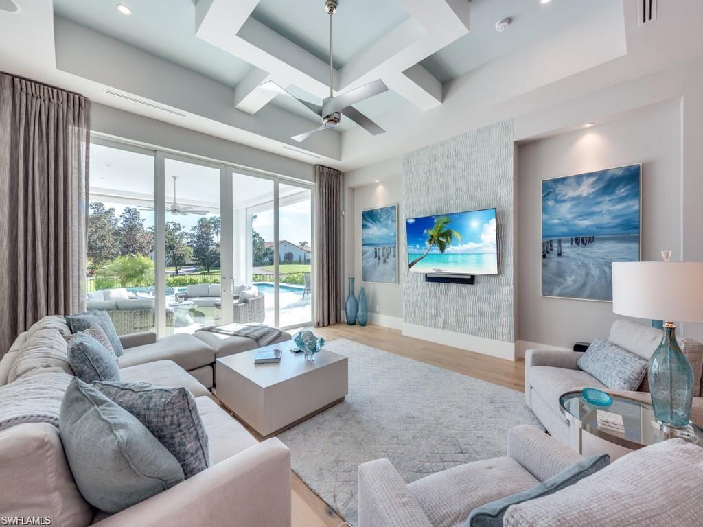 16892 Brightling Way Naples, FL 34110 - Photo 2 of 33 a living room with furniture and a flat screen tv
