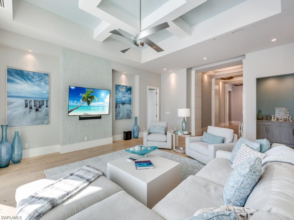 16892 Brightling Way Naples, FL 34110 - Photo 3 of 33 a living room with furniture and a flat screen tv