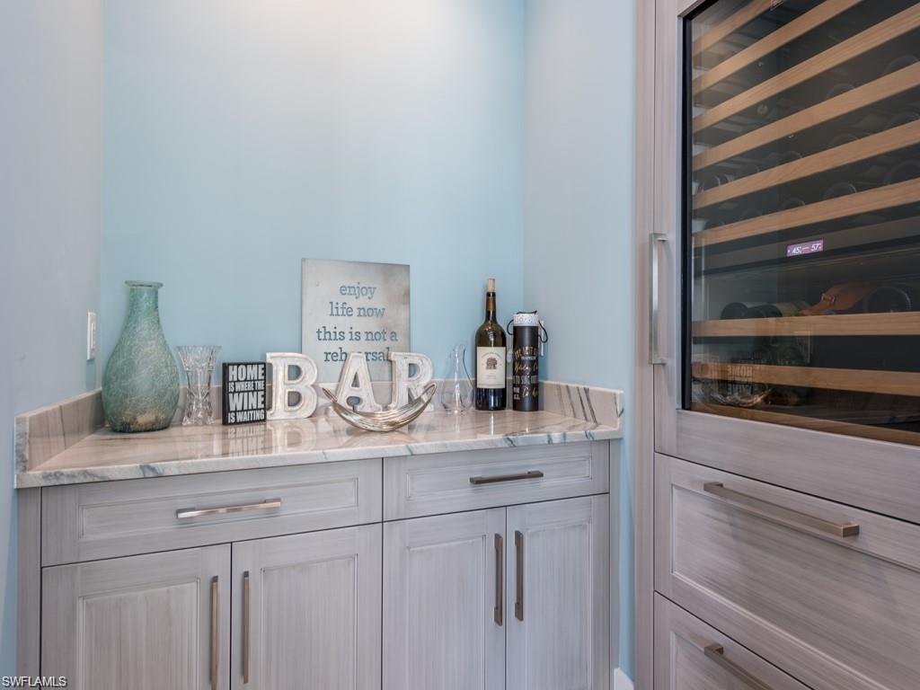 16892 Brightling Way Naples, FL 34110 - Photo 7 of 33 a bathroom with a sink and a mirror