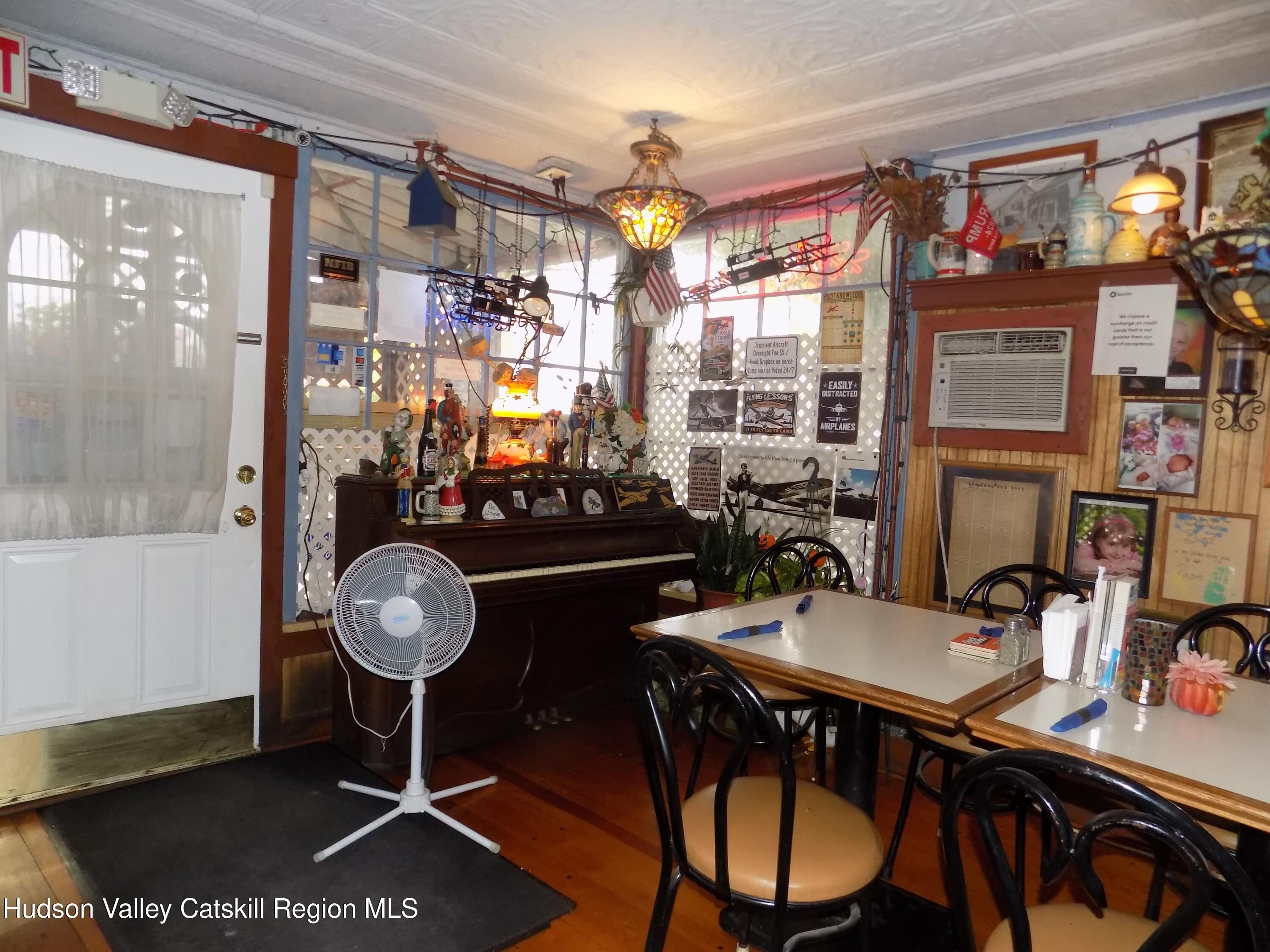 3663 Rte 67 Freehold, NY 12431 - Photo 11 of 36 a view of a dining room with furniture window and wooden floor