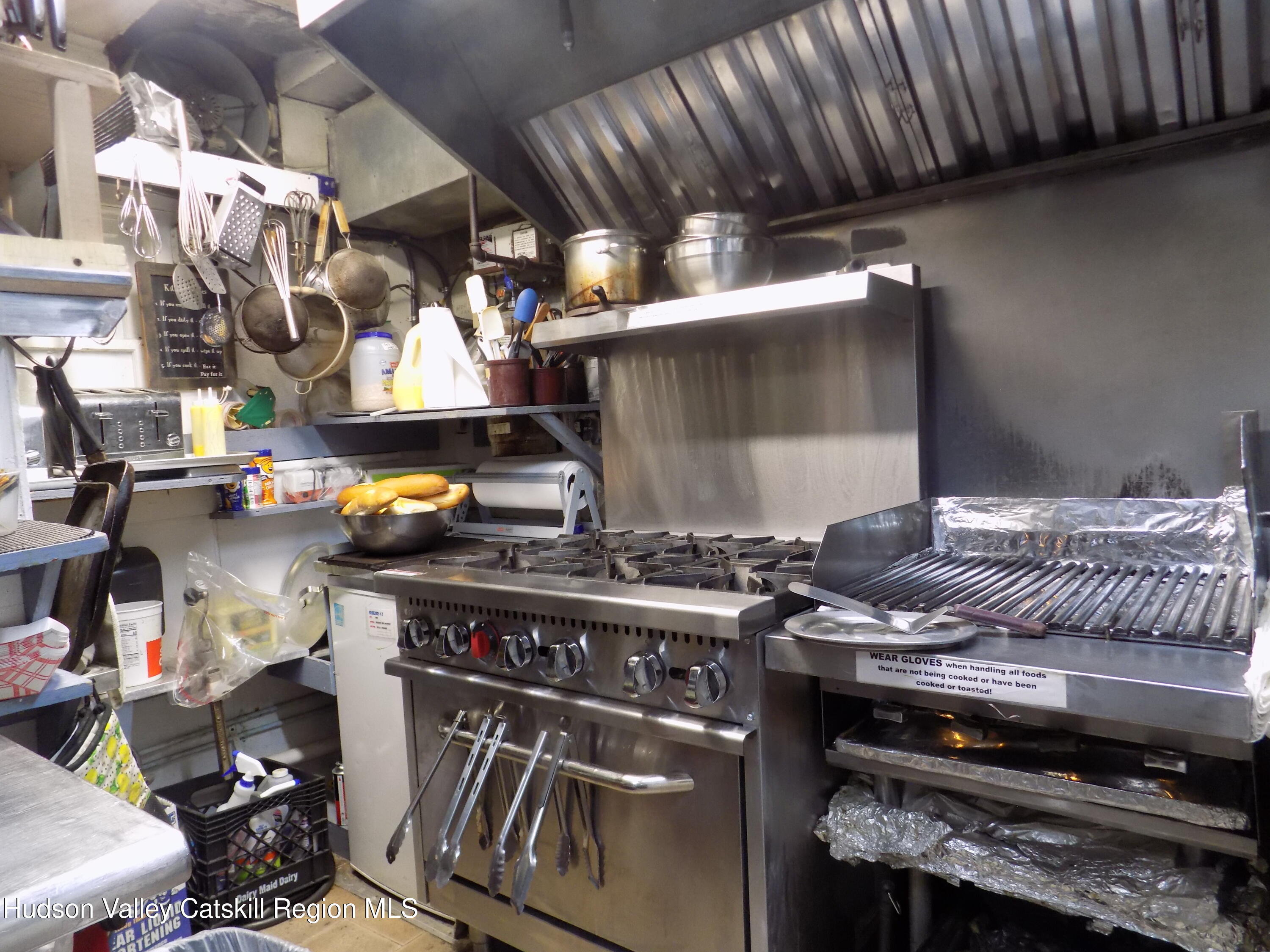 3663 Rte 67 Freehold, NY 12431 - Photo 13 of 36 a kitchen with a stove and a wooden floor