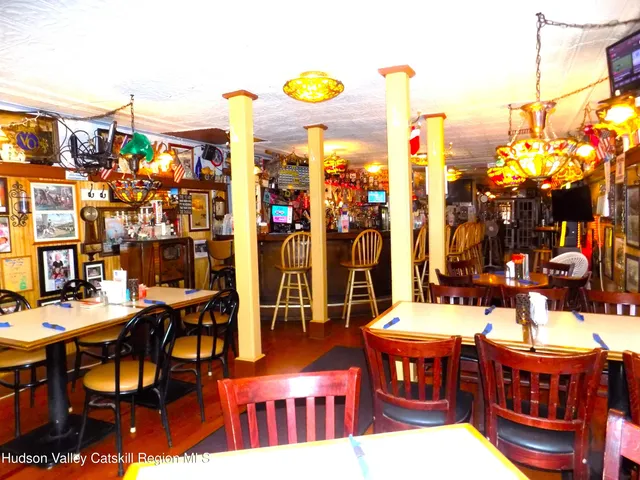a kitchen with a stove and a wooden floor