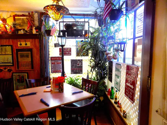 a utility room with stainless steel appliances kitchen island granite countertop a refrigerator and a stove