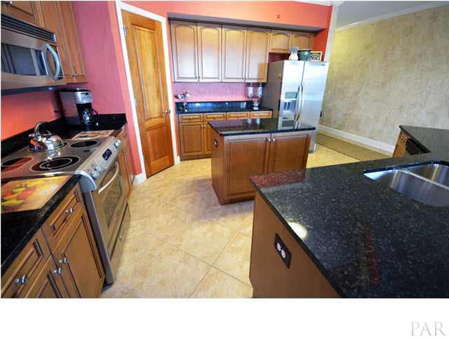 Modern, spacious kitchen with large bar for entertaining and loads of cabinet space