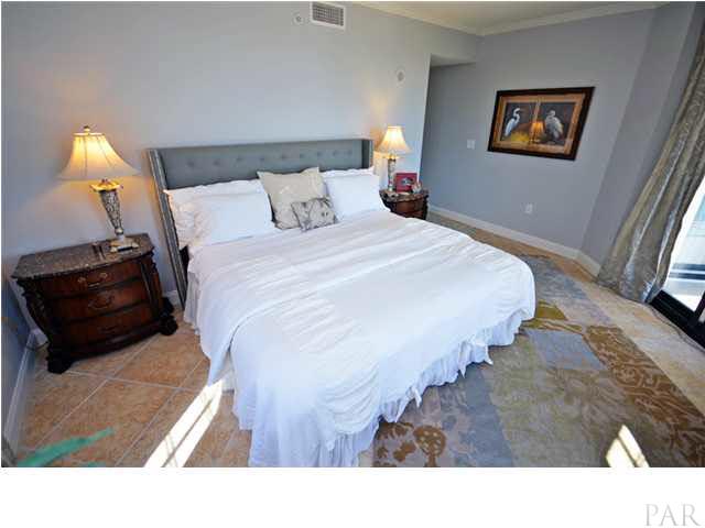 Master bedroom suite with king size bed and sliding glass door with direct access to balcony