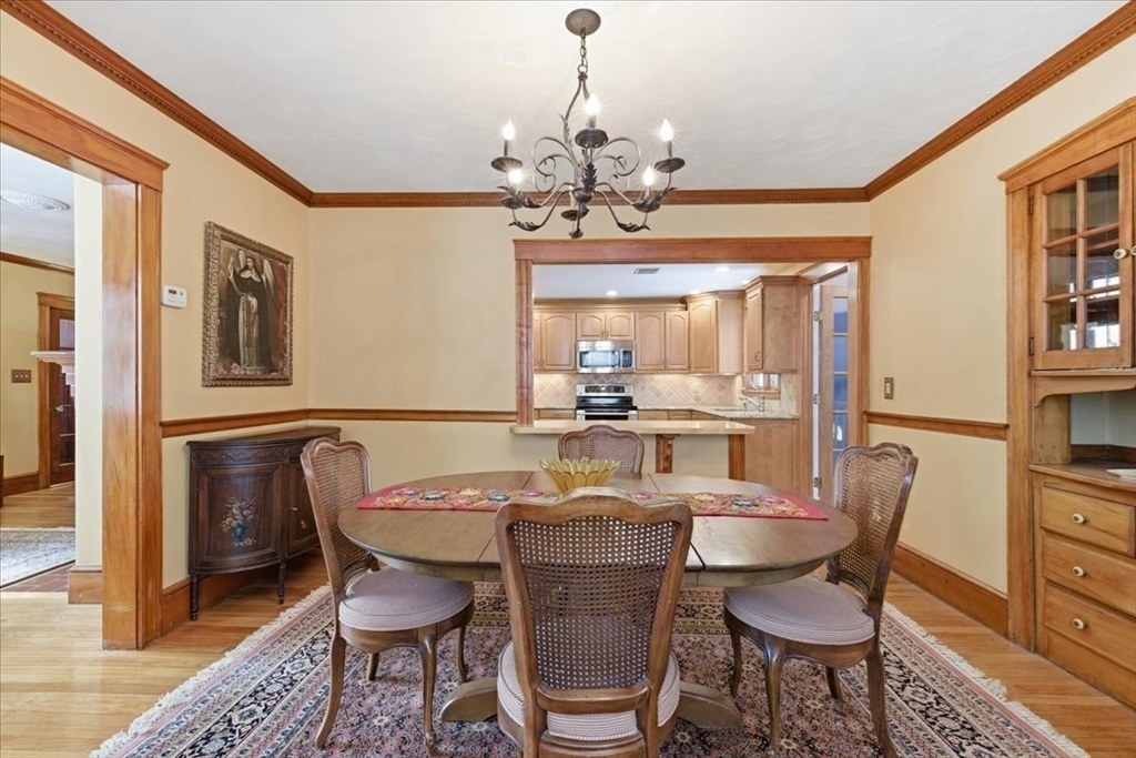 7 West Street Needham, MA 02494 - Photo 11 of 36 a dining room with furniture a chandelier and wooden floor