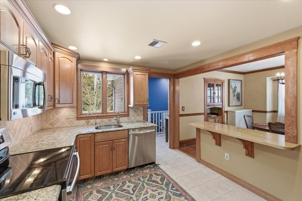 7 West Street Needham, MA 02494 - Photo 14 of 36 a large white kitchen with a large window