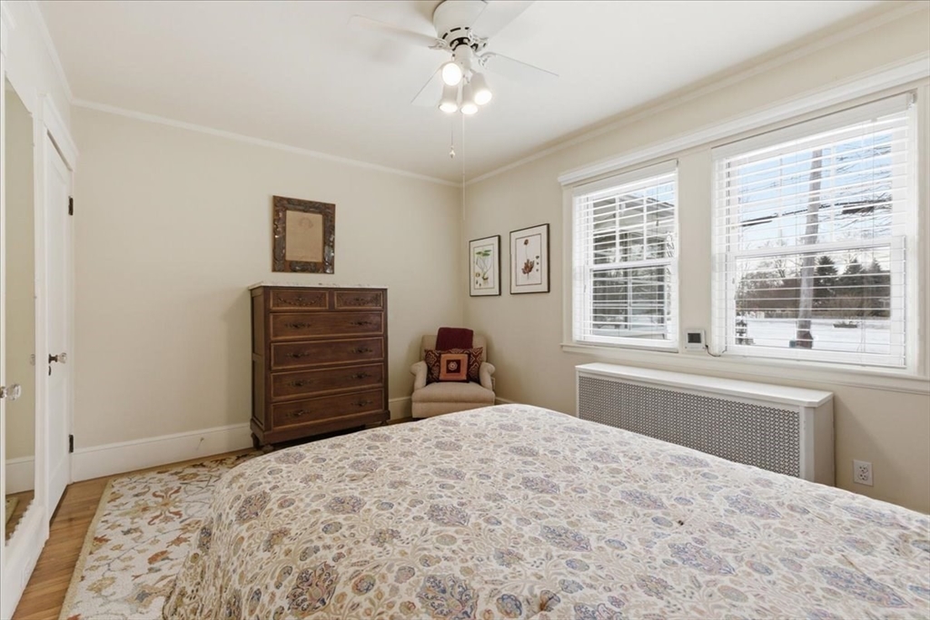 7 West Street Needham, MA 02494 - Photo 17 of 36 a bedroom with a bed dresser and a large window