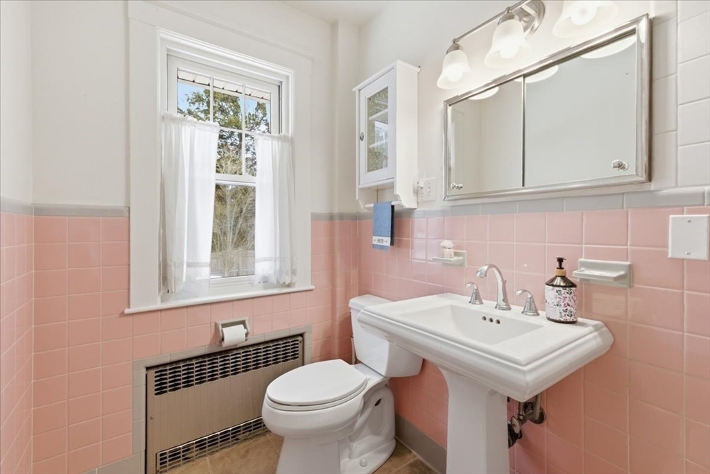 7 West Street Needham, MA 02494 - Photo 18 of 36 a bathroom with a sink a toilet and a mirror